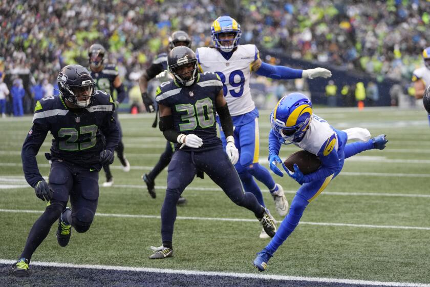 Rams receiver Tutu Atwell (right) makes a touchdown catch against the Seattle Seahawks.