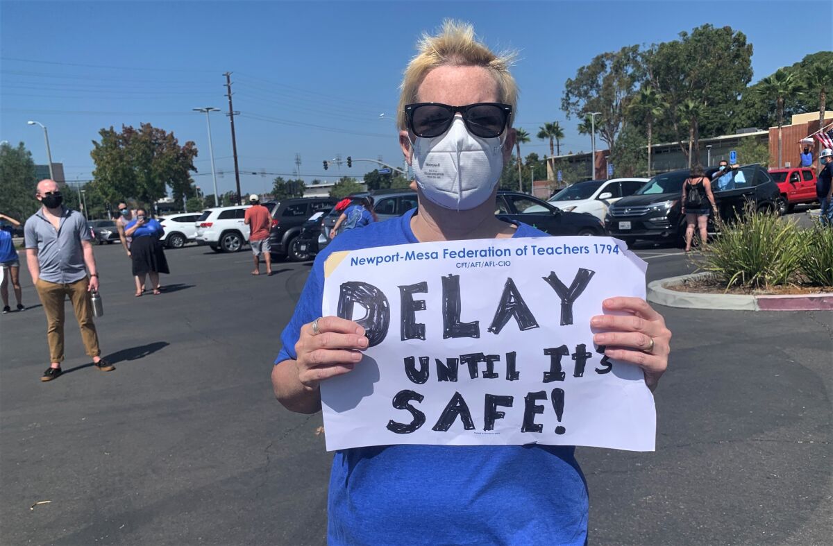 Orange County teachers and union members protest school reopenings at a demonstration at Costa Mesa High School.