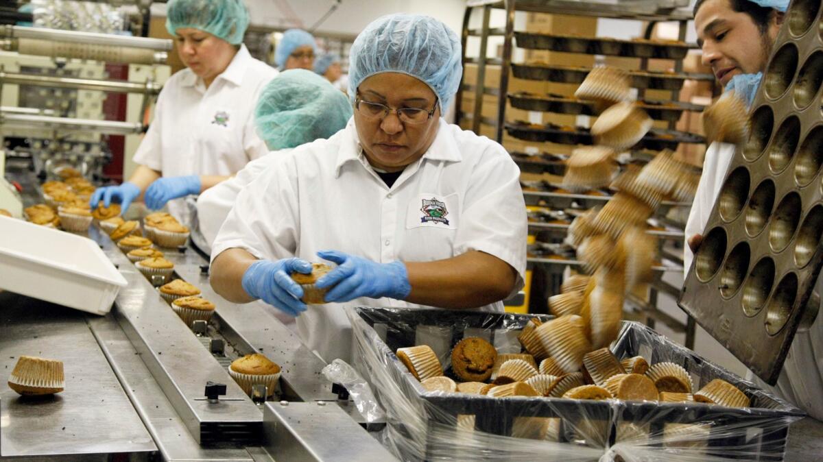Mandates of 100% whole wheat? No problem for L.A. Unified, for which these workers are packaging the "Glorious Morning Muffin" at Buena Vista Food Products in Azusa in 2013.
