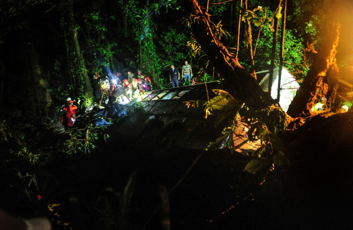Rescue crews work at the scene of a bus accident in Campo Alegre, southeastern Brazil.