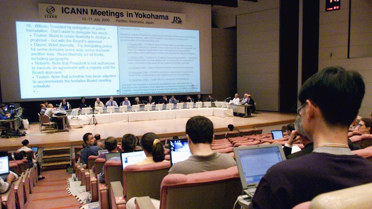 Participants listen to the board of directors (sitting on the stage) during a meeting of the Internet Corp. for Assigned Names and Numbers in Yokohama, Japan, on July 16, 2000.