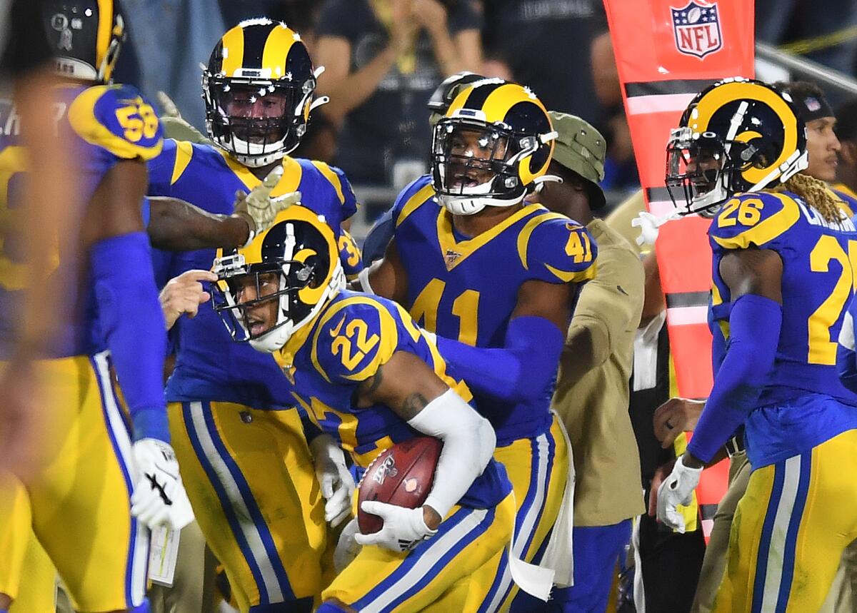 Rams cornerback Troy Hill (22) celebrates his interception with teammates during the second quarter of their game against the Bears on Sunday. 
