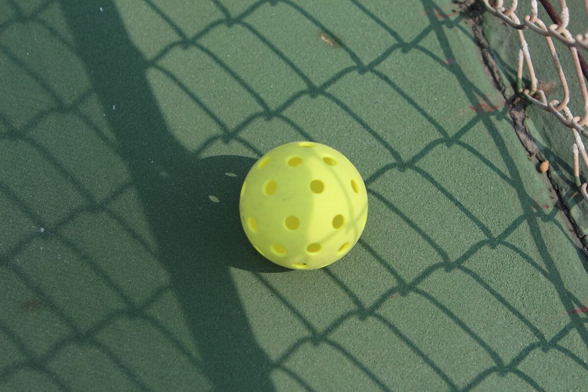 Pickleball is played with a small plastic ball similar to a Wiffle ball.
