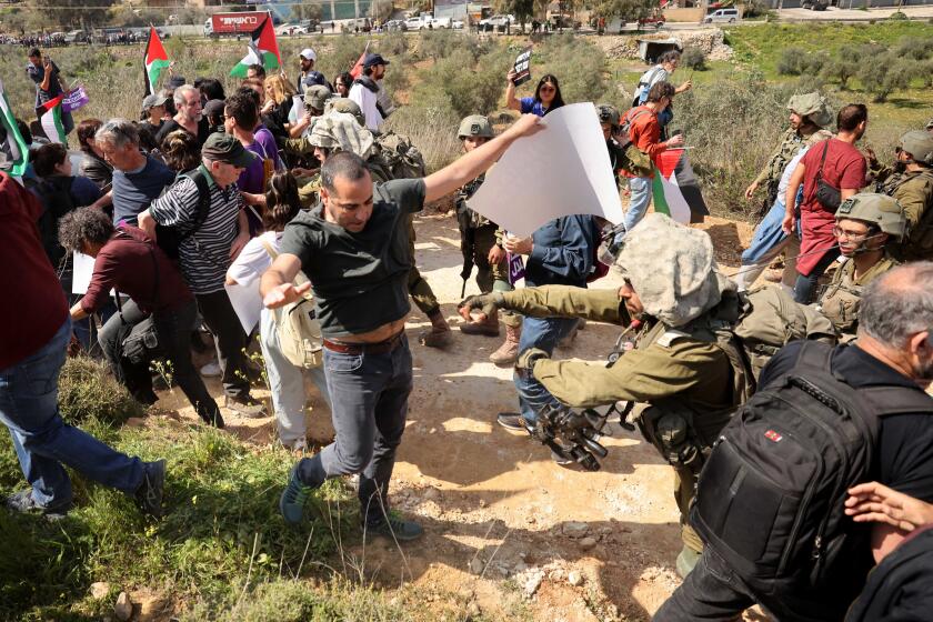 Protesters clash with Israeli security forces at the entrance to the town of Hawara, south of the northern West Bank city of Nablus, on March 3, 2023. A senior Palestinian official on Wednesday condemned an Israeli minister's calls to "erase" the town of Hawara, which was subjected to an assault by Israeli settlers two days ago. (Photo by Ayman Nobani/Xinhua via Getty Images)
