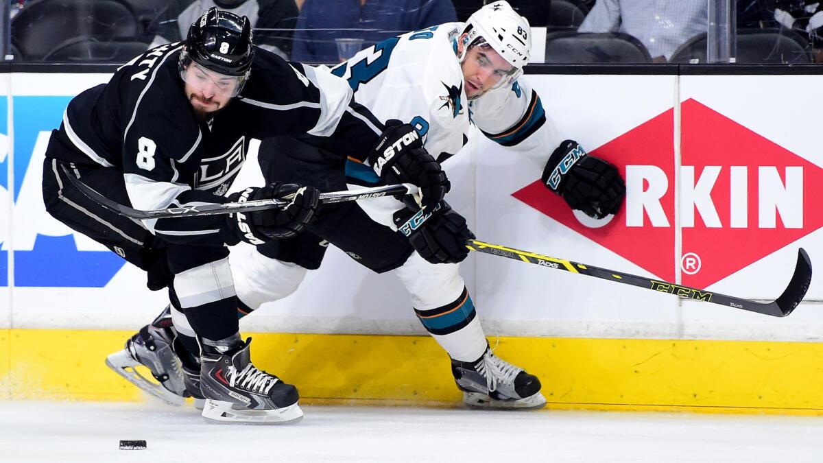Kings defenseman Drew Doughty takes the puck from Sharks left wing Matt Nieto during the third period Thursday.