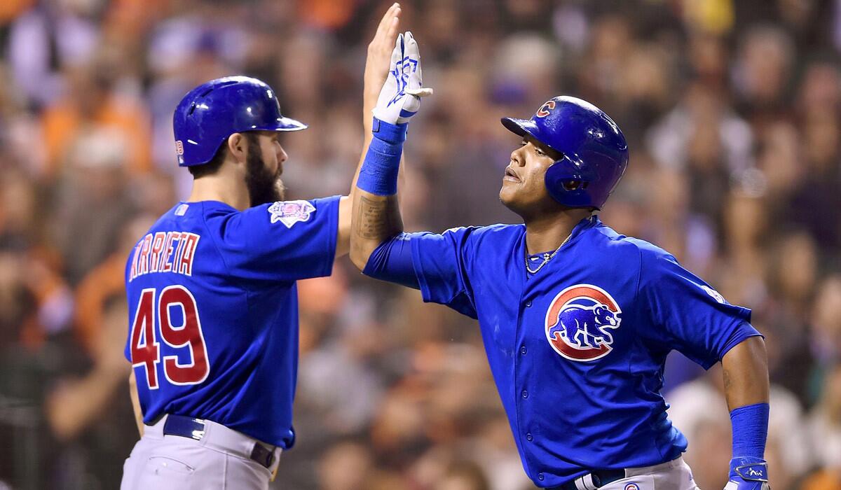 Chicago Cubs' Starlin Castro is congratulated by Jake Arrieta after Castro hit a solo home run against the San Francisco Giants on Tuesday.