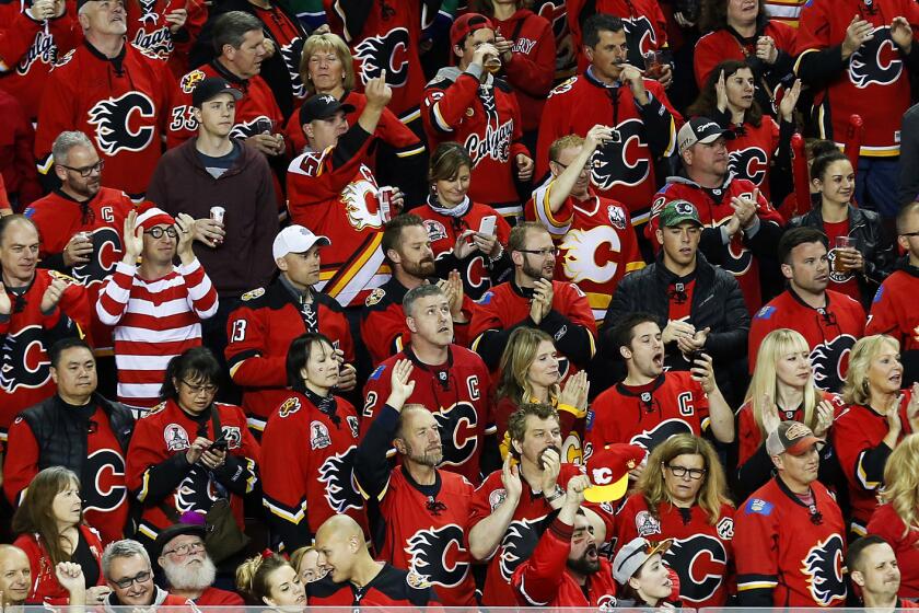 Calgary Flames fans cheer on their team during Game 6 of the Western Conference quarterfinals against the Vancouver Canucks on April 25.