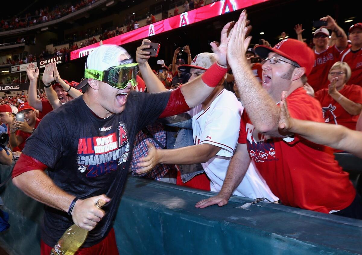 Mike Trout celebrates with fans after the Angels clinched the American League West Division at Angel Stadium on Sept 17.