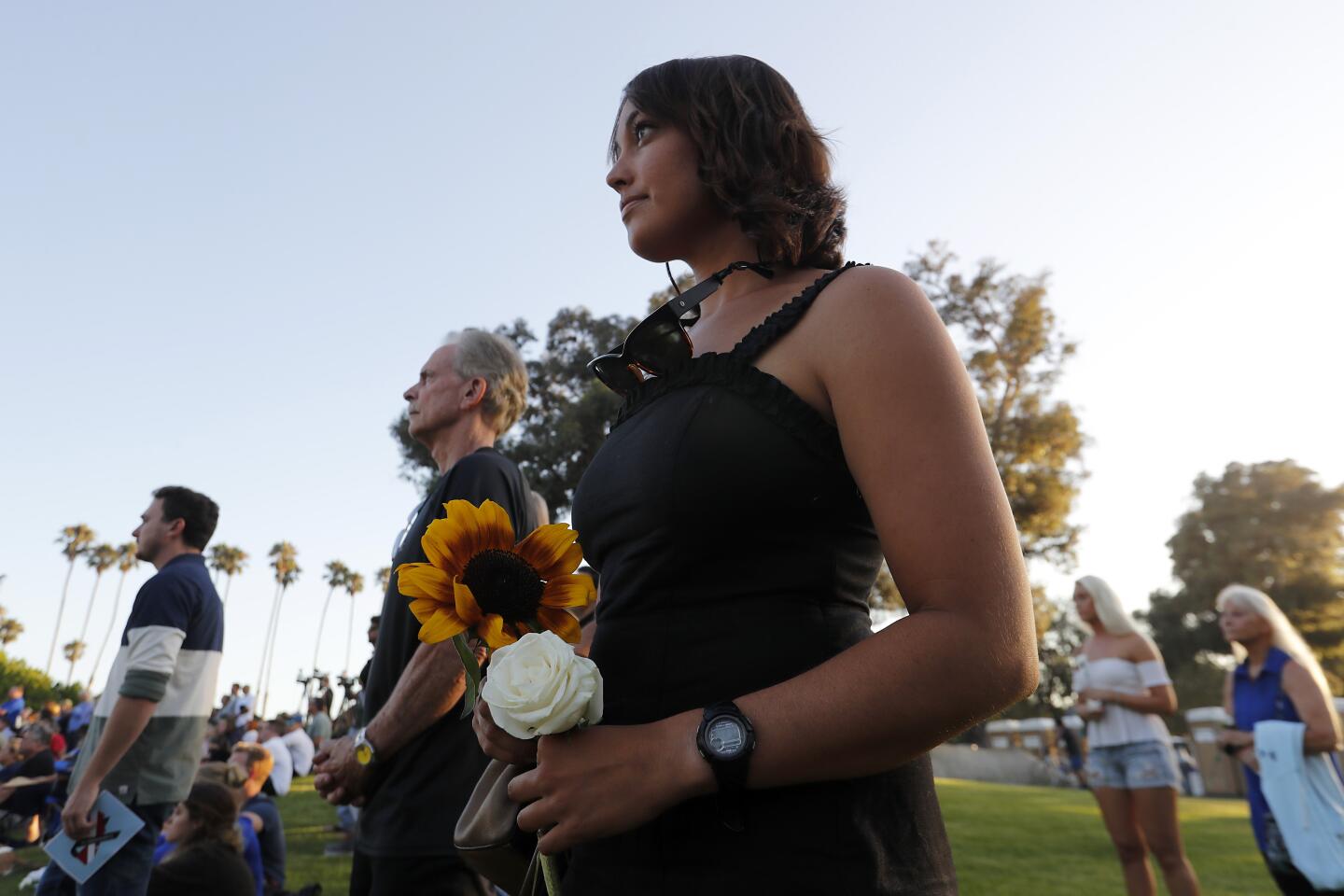 Scuba diver Julia Donath joins mourners for a vigil at Chase Palm Park in Santa Barbara on Friday evening to honor the 34 victims that died in the Conception boat fire.