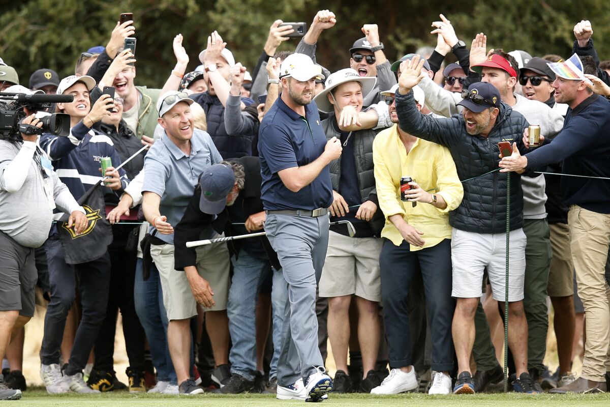 Australian Marc Leishman of the International team celebrates with fans after his shot on the 18th hole during a foursome match on Dec. 14 at the Presidents Cup.