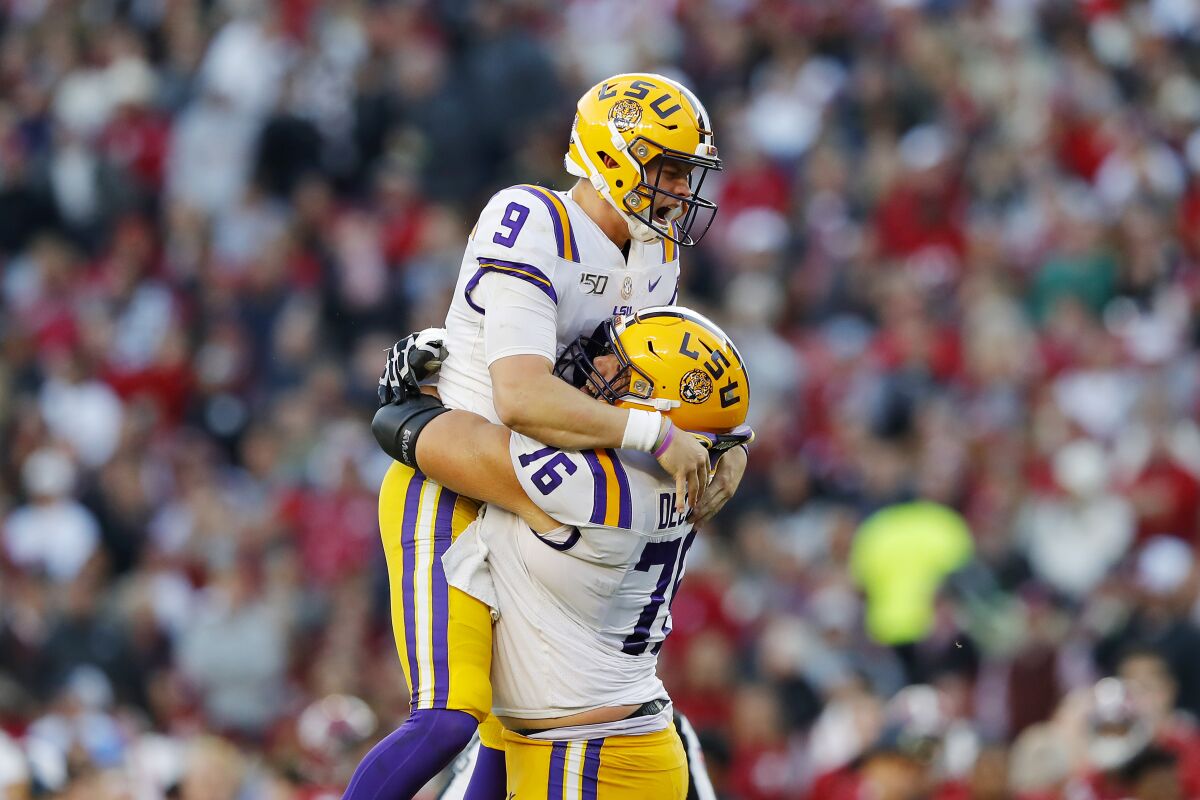 LSU quarterback Joe Burrow (9) celebrates after throwing a 13-yard touchdown pass during the second quarter against Alabama on Saturday. The Tigers won 46-41.