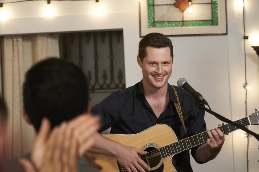 Noah Reid performing a romantic rendition of Tina Turner's "The Best" in "Schitt's Creek" — a scene that inspired him to take up his music career once more.