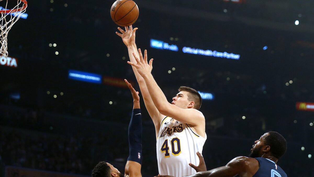 Lakers center Ivica Zubac attempts a shot over Grizzlies forward JaMychal Green, left, and guard Garrett Temple during the first half Sunday.