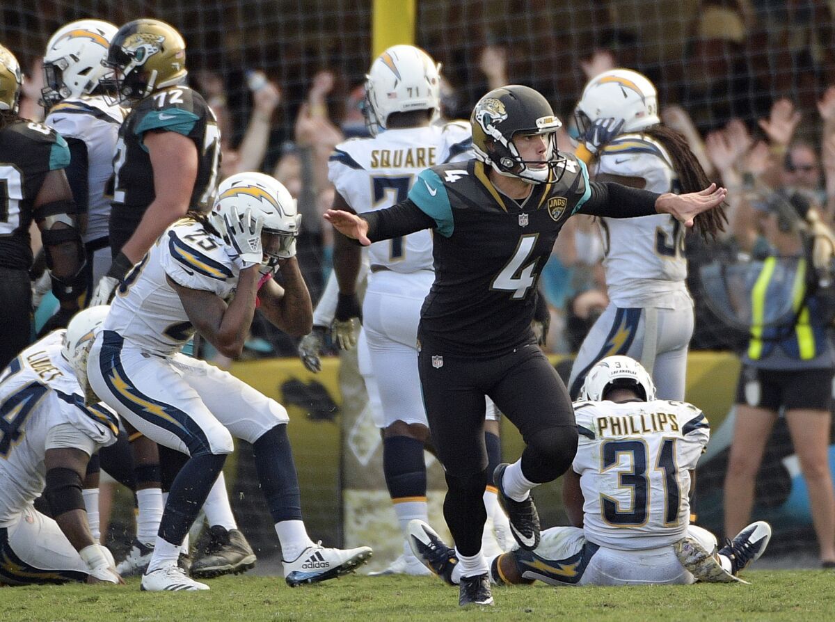 Jacksonville Jaguars kicker Josh Lambo (4) celebrates his game winning field goal as Los Angeles Chargers players including safety Rayshawn Jenkins (25) and safety Adrian Phillips (31) react during the second half of game on Nov. 12, 2017, in Jacksonville, Fla. Jacksonville won 20-17 in overtime.