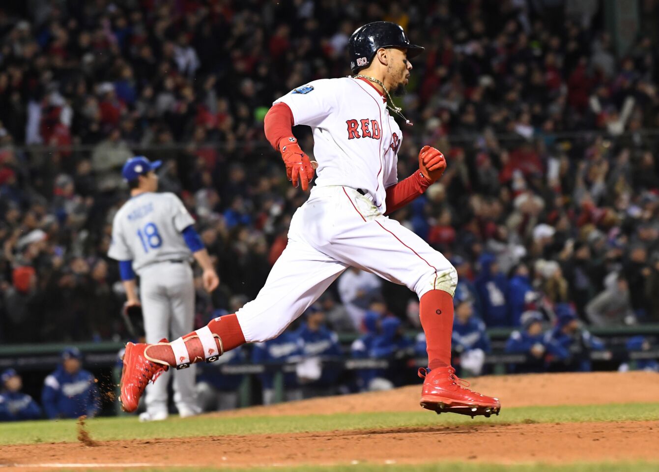 Red Sox's Mookie Betts scores a run in the fifth inning of game two of the World Series against the Dodgers at Fenway Park.