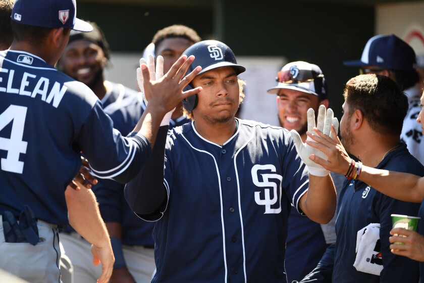 Josh Naylor celebrates after hitting a solo home run for the Padres during a spring training game.