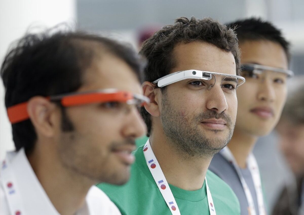Google Glass team members wear Google Glass at a booth at Google's annual developers conference in San Francisco.