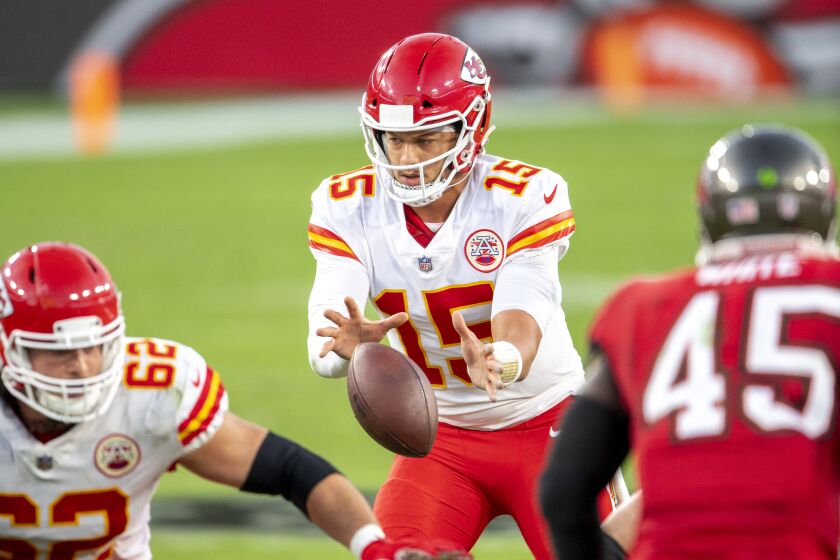 Kansas City Chiefs quarterback Patrick Mahomes (15) takes the snap of the ball as the Chiefs take on the Tampa Bay Buccaneers during an NFL football game, Sunday, Nov. 29, 2020, in Tampa, Fla. (AP Photo/Doug Murray)