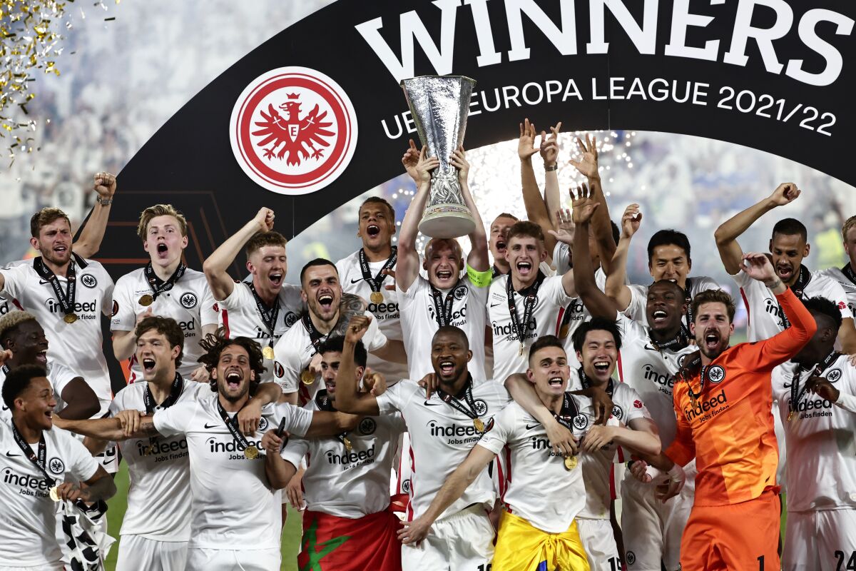 Frankfurt players lift the trophy for winners of the Europa League final soccer match between Eintracht Frankfurt and Rangers FC at the Ramon Sanchez Pizjuan stadium in Seville, Spain, Thursday, May 19, 2022. (AP Photo/Pablo Garcia)