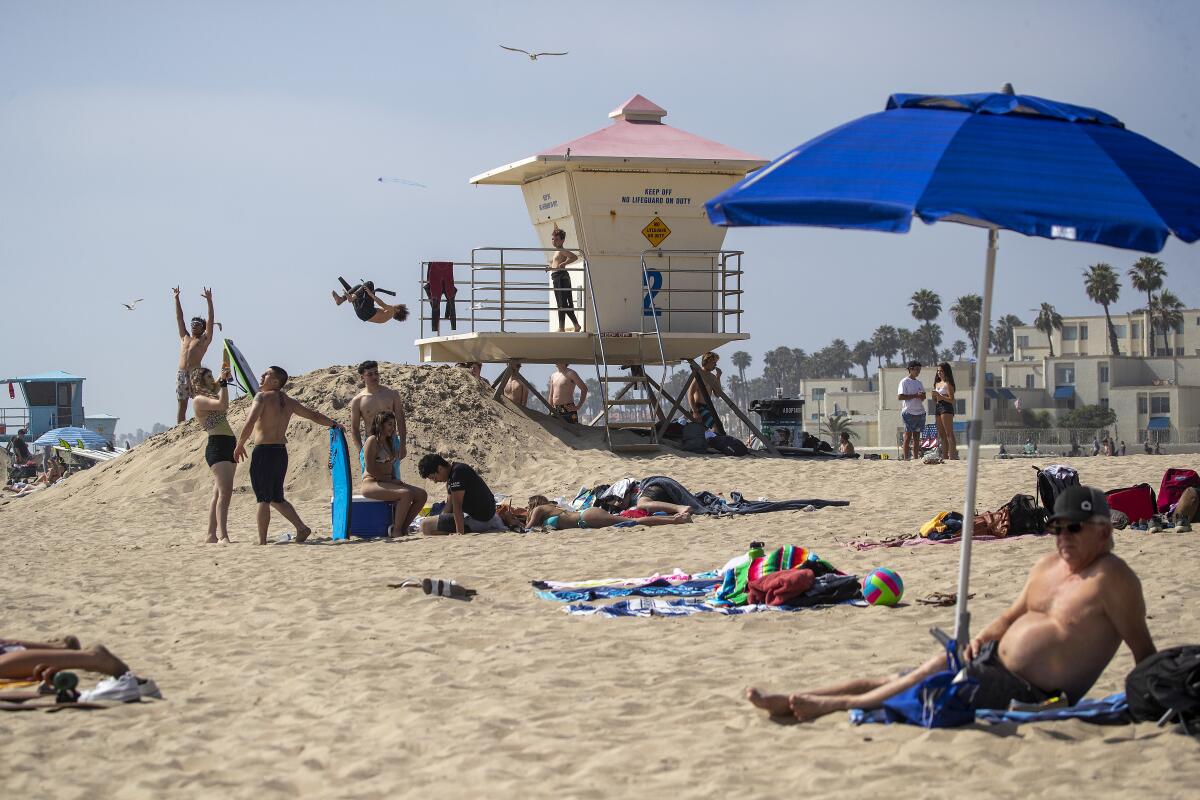 People on the sand at Huntington Beach