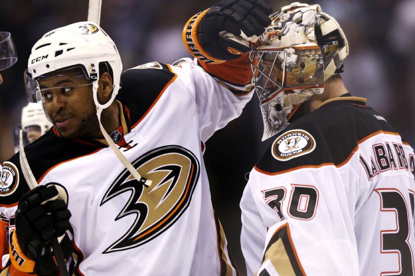 Ducks right wing Devante Smith-Pelly congratulates goalie Jason LaBarbera after the Ducks' 3-2 victory over the Colorado Avalanche on Sunday in Denver.