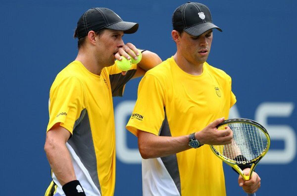 Bob Bryan discusses strategy with brother Mike during a third-round doubles match Sunday at the U.S. Open.