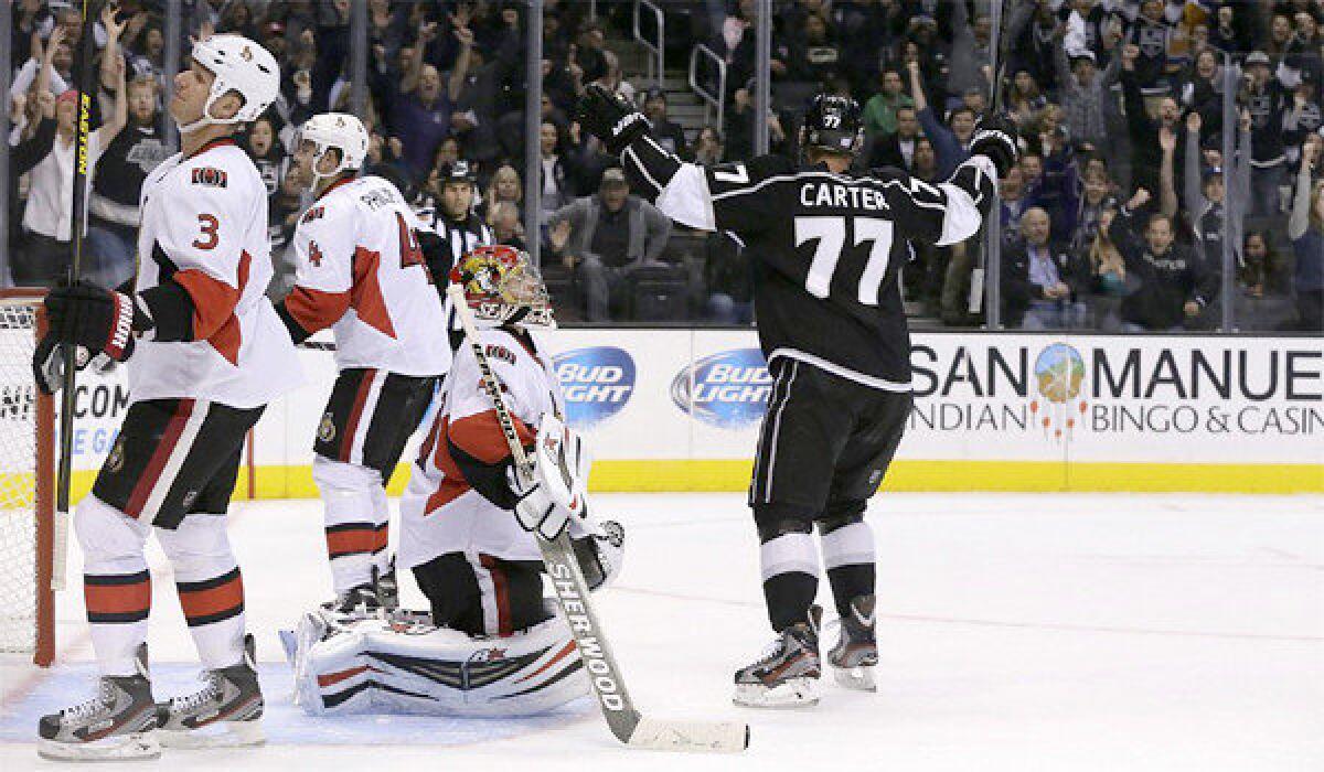 Jeff Carter celebrates after scoring the game-winning goal in overtime to give the Kings a 4-3 victory over the Ottawa Senators.