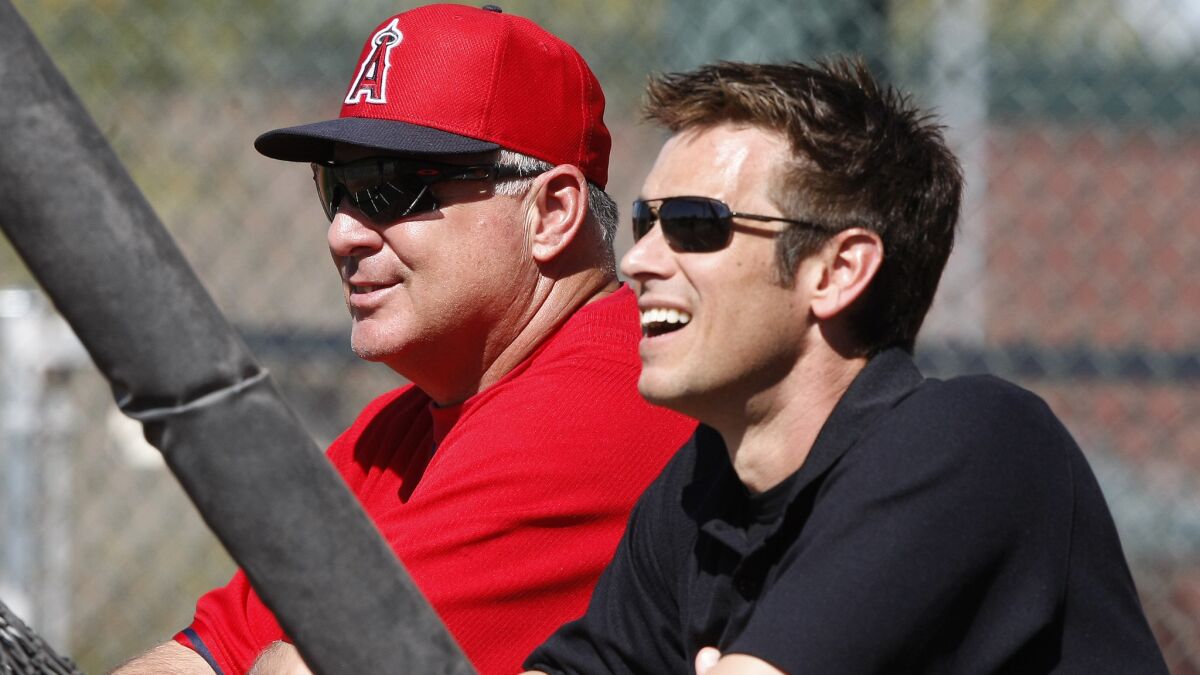 Angels Manager Mike Scioscia, left, and General Manager Jerry Dipoto watch batting practice during spring training in Feburary. Dipoto, a former MLB relief pitcher, has worked to improve the Angels' bullpen this season.