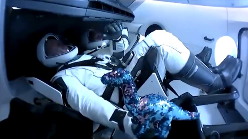 The astronauts with their zero-gravity indicator.
