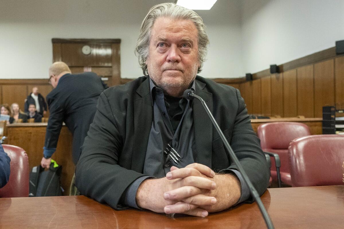 Stephen K. Bannon sits in a courtroom with clasped hands.