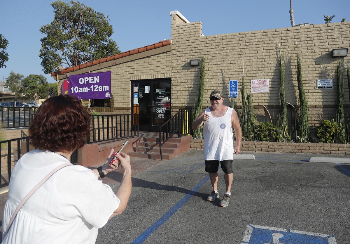 Laguna resident Matt McCullough poses in front of Orange County's oldest Taco Bell in Laguna Beach. 