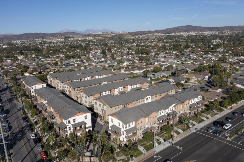 Yorba Linda, CA - November 24: An aerial view of the Heritage Crossings 3-story condo and apartment buildings built in 2016 amidst a community mostly consisting of single-story, single family houses on Wednesday, Nov. 24, 2021. Orange County cities are pushing back against state requirements for regions to build more dense housing projects. (Allen J. Schaben / Los Angeles Times)