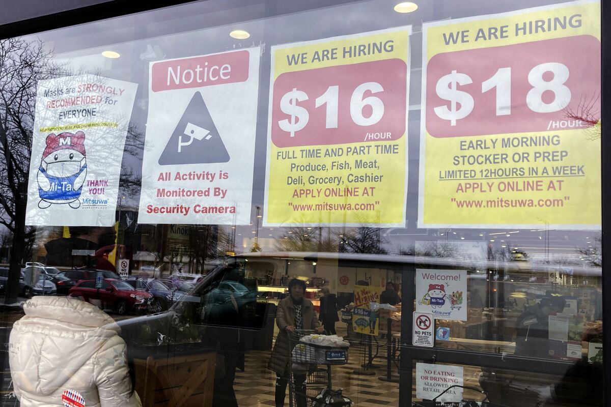 FILE - Hiring signs are displayed at a grocery store in Arlington Heights, Ill., Jan. 13, 2023. Employers are increasingly posting salary ranges for job openings, even in states where it's not mandated by law, according to analysts with employment sites Indeed, GlassDoor, and Monster. (AP Photo/Nam Y. Huh, File)