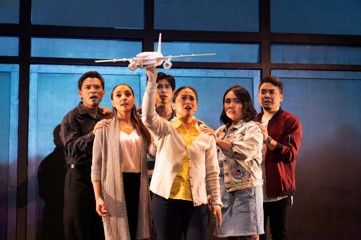 The cast of "On This Side of the World." One actor holds an airplane. 