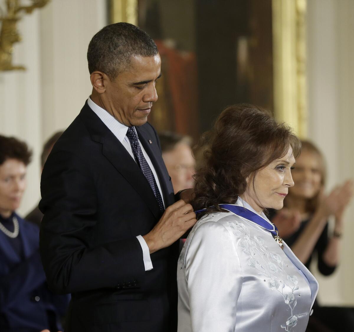 President Obama awards country music legend Loretta Lynn the Presidential Medal of Freedom on Nov. 20, 2013, during a ceremony at the White House in Washington.
