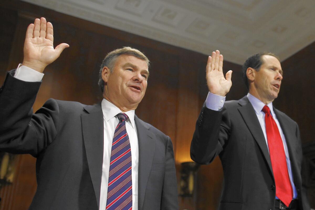 DirecTV Chief Executive Michael D. White, left, and AT&T CEO Randall L. Stephenson are sworn in before testifying at a Senate subcommittee hearing about their companies' proposed merger in June 2014.