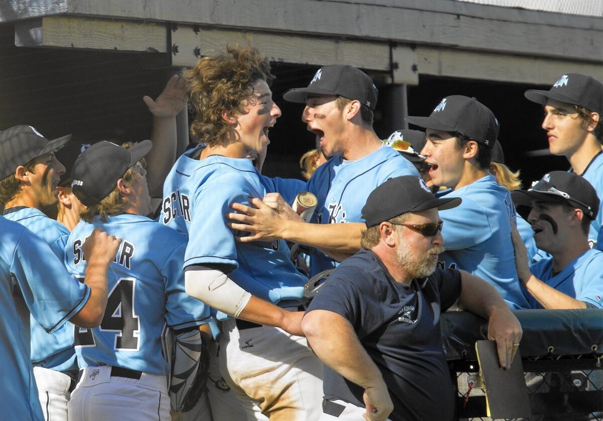 Corona del Mar High's J.T. Schwartz, left, celebrates with teammates after scoring against Newport Harbor during the Battle of the Bay on Monday.
