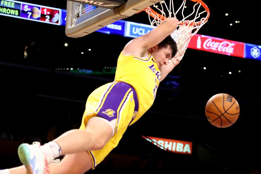 LOS ANGELES, CALIF. - NOV. 30, 2022. Lakers guard Austin Reaves throws down a dunk against the Blazers in the first quarter of the game at crypto.com Arena in Los Angeles on Wednesday night, Nov. 30, 2022. (Luis Sinco / Los Angeles Times)