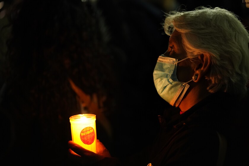 A woman holds a candle during a national protest against attacks on journalists in Mexico