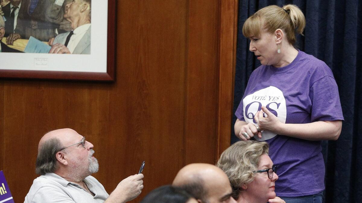Amy Kamm, vice president of communications for the Burbank Educational Foundation, shown here talking with Measure QS opponent Larry Applebaum, thinks her organization can raise $2.5 million to help the Burbank Unified School District address proposed cuts.