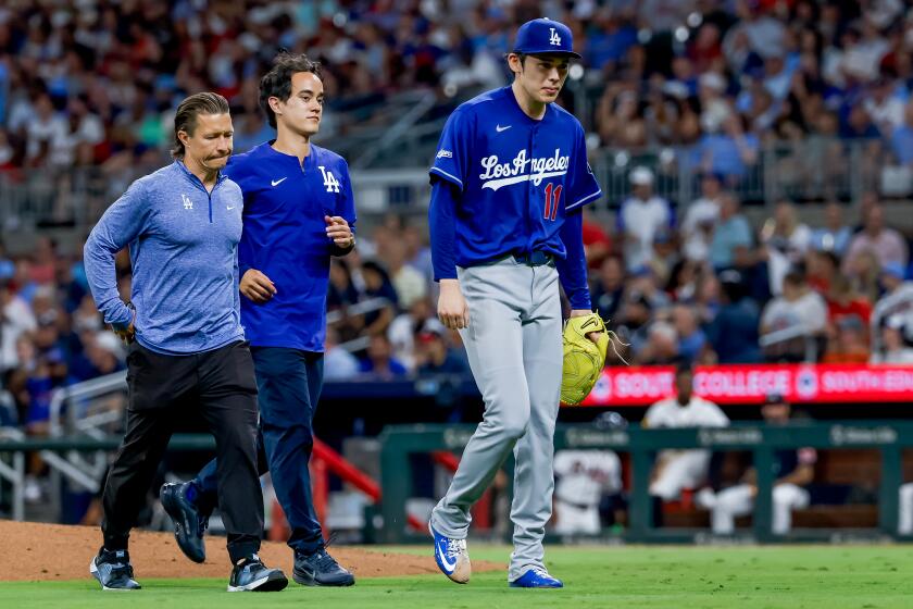 Los Angeles Dodgers pitcher Roki Sasaki (11) leaves the game with an injury against the Atlanta Braves during the fourth inning of a baseball game, Wednesday, Aug. 26, 2026, in Atlanta. (AP Photo/Erik S. Lesser)