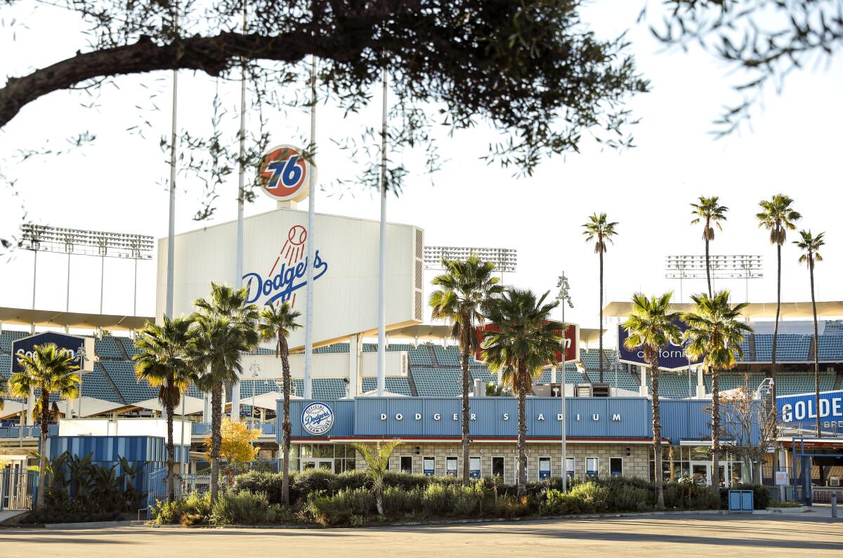 The outside of Dodger Stadium surrounded by palm trees.