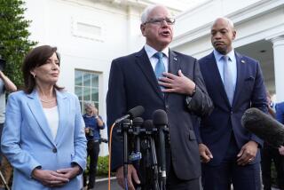 Minnesota Gov. Tim Walz, center, standing with New York Gov. Kathy Hochul, left, and Maryland Gov. Wes Moore, right, talks with reporters following their meeting with President Joe Biden at the White House in Washington, Wednesday, July 3, 2024. (AP Photo/Susan Walsh)