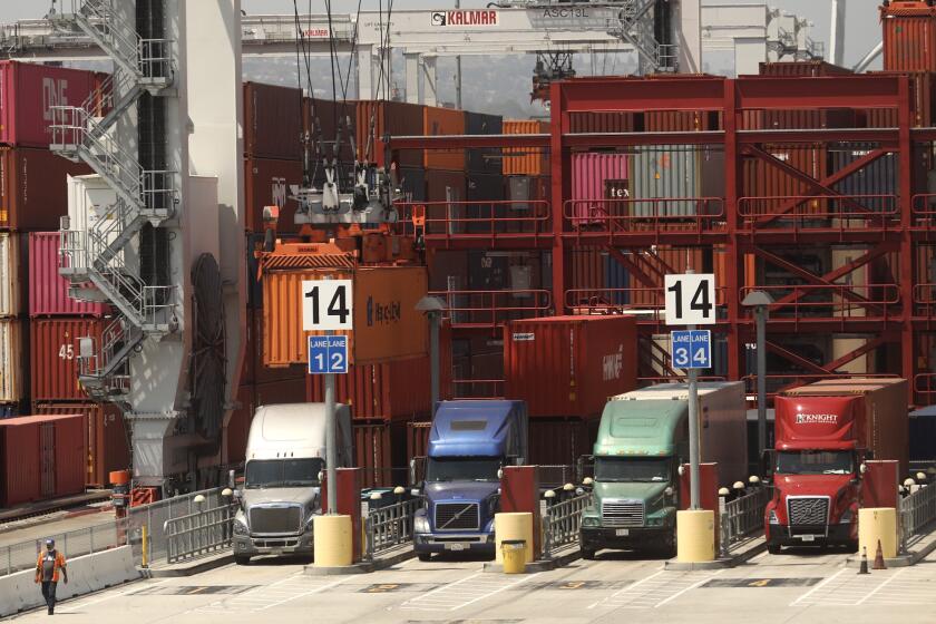 SAN PEDRO CA. AUGUST 27, 2020 - Trucks line up to drop off their loads at the Port of Los Angeles in August 28, 2020. California air quality officials are poised to adopt their biggest pollution-cutting regulations in more than a decade, targeting diesel trucks and cargo ships that spew much of the state's cancer-causing and smog-forming emissions. The state Air Resources Board is expected to vote after a public hearing Thursday on two rules: one to establish stringent new emissions standards for heavy-duty diesel trucks and one to reduce pollution from ships docked at ports. (Genaro Molina/Los Angeles Times)