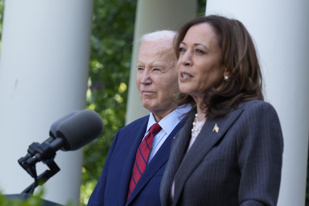 President Biden and Vice President Kamala Harris stand together at the White House.