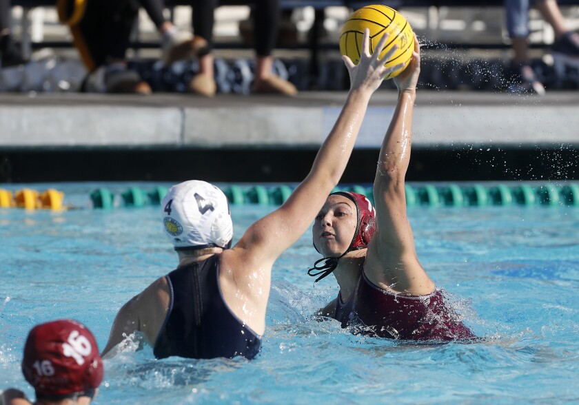 Laguna Beach junior attacker Emma Lineback scores on Newport Harbor sophomore Morgan Netherton (4) during the first half in the semifinals of the Bill Barnett Holiday Cup on Saturday at Newport Harbor High.