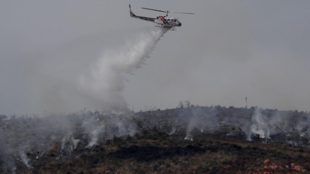 Aircraft work to douse the Stone fire in Agua Dulce, which grew to about 1,400 acres and was 30% contained Tuesday morning.