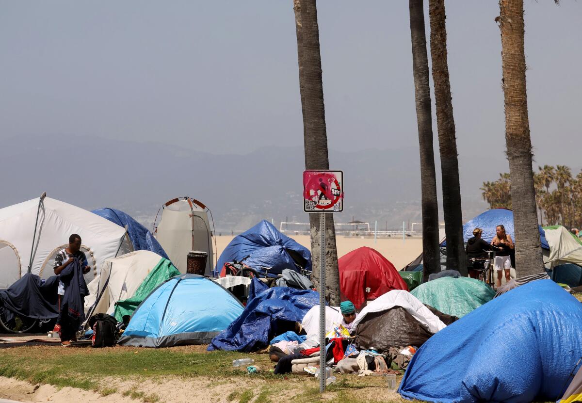 A sea of tents takes over an area between the bike path and Ocean Front Walk in Venice 