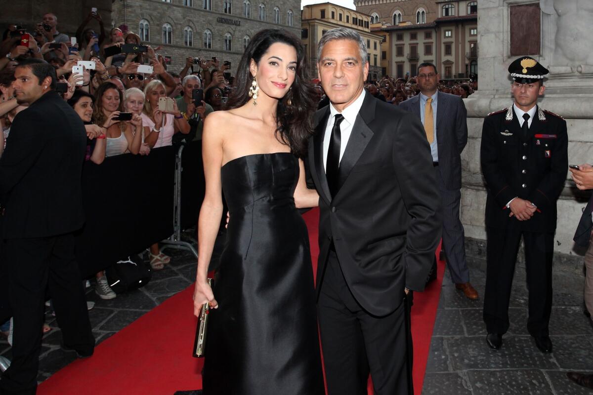 Amal Alamuddin and George Clooney attend the Celebrity Fight Night gala in Florence, Italy, on Sept. 7.