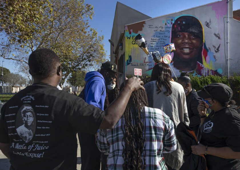 A crowd gathers at a mural of Latasha Harlins at the Algin Sutton Recreation Center in Los Angeles.